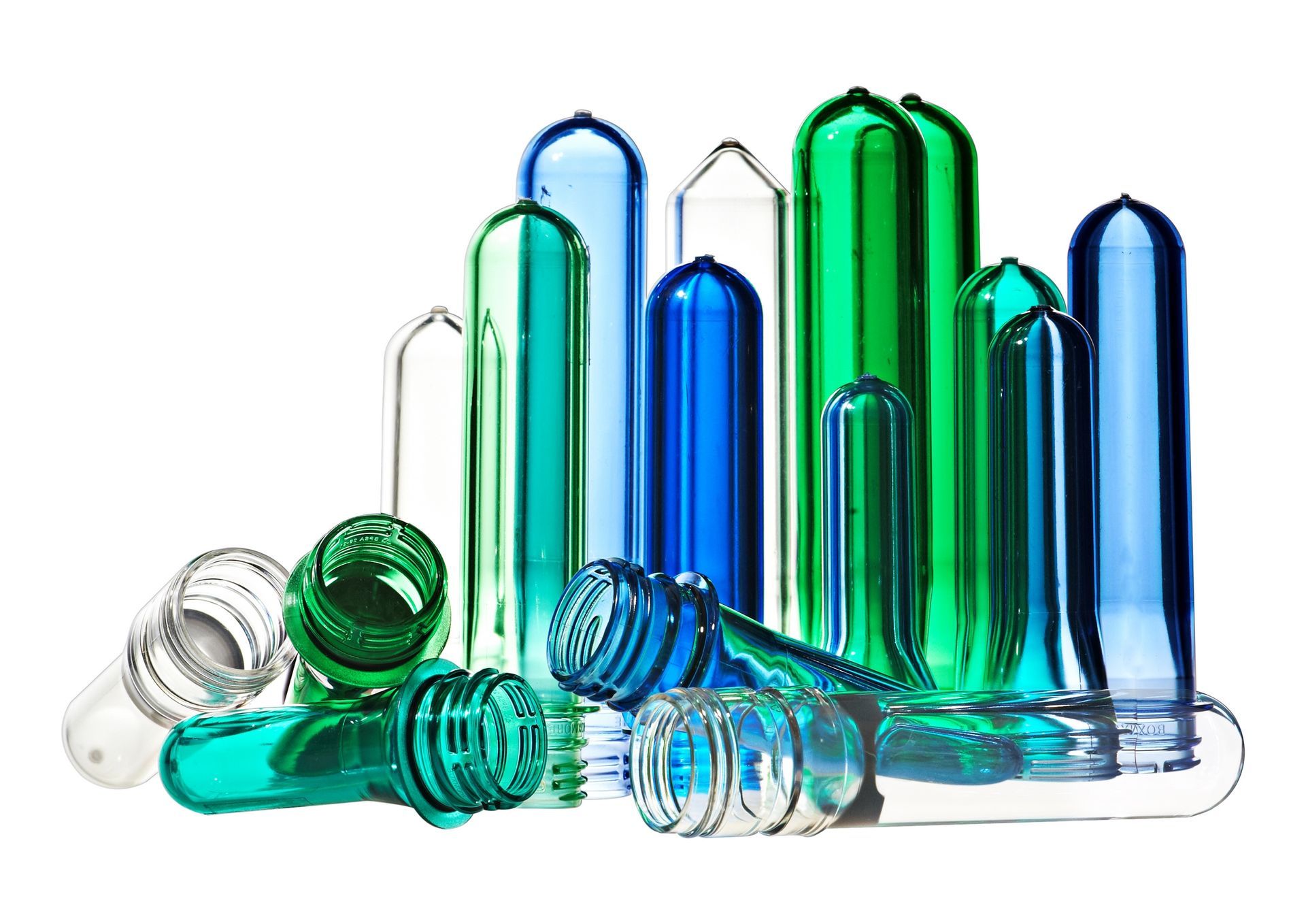 A bunch of different colored plastic bottle preforms on a white background.