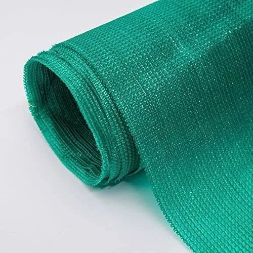 A roll of green shade net on a white surface.