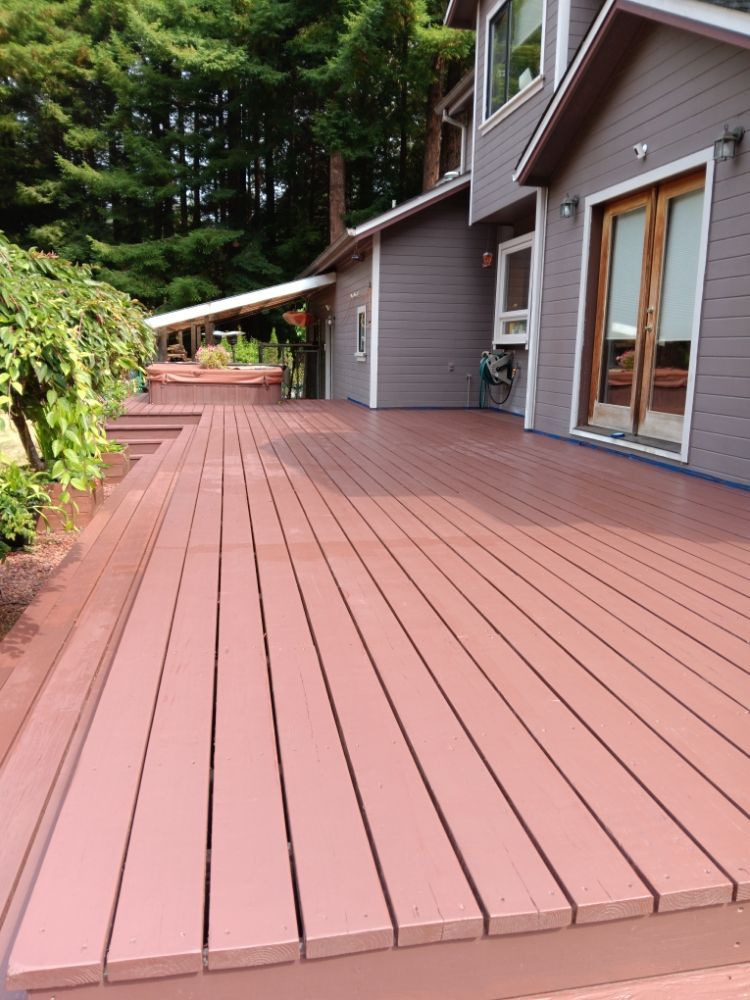 A house with a large deck in front of it