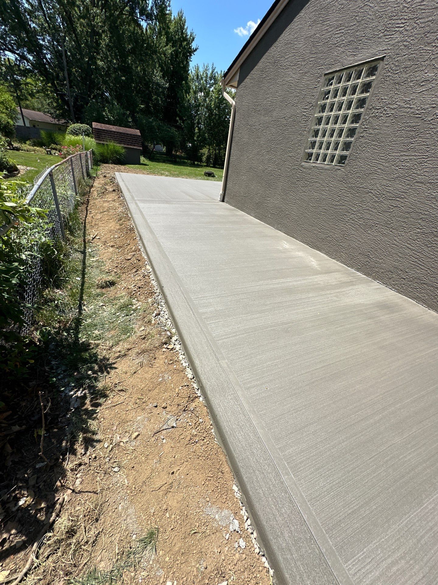 A concrete walkway is being built in front of a house.