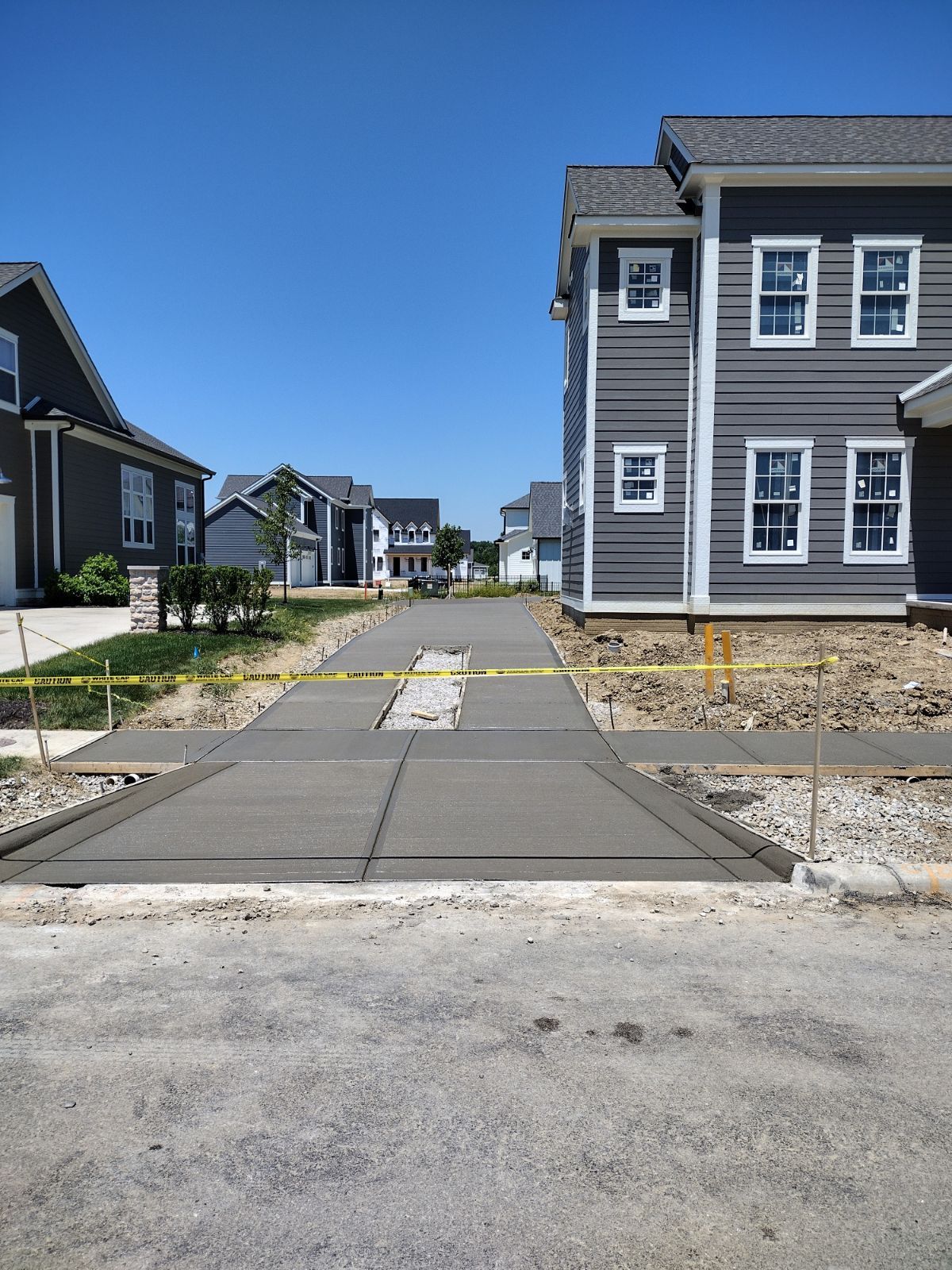 A row of houses are being built in a residential area