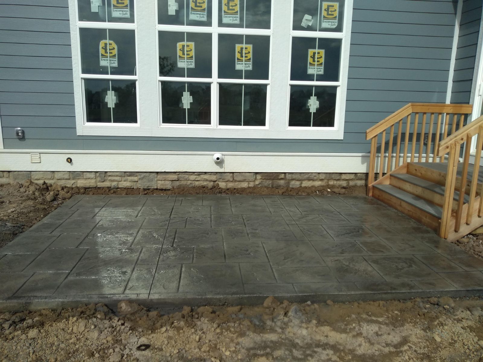 A house with a concrete patio in front of it