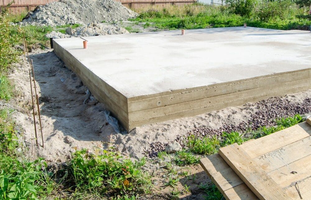 A Concrete Slab Is Sitting In The Middle Of A Dirt Field — JGA Concreting Pty Ltd In Berrimah, NT