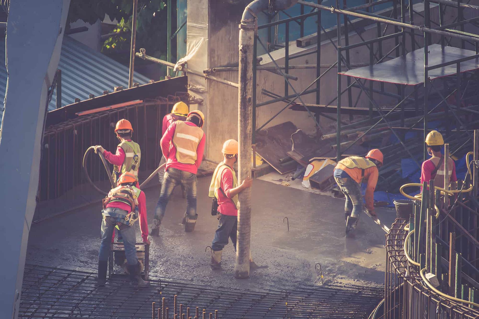 A Group Of Construction Workers Are Working On A Construction Site — JGA Concreting Pty Ltd In Berrimah, NT