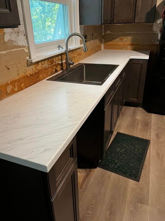 A kitchen with a sink and a window.