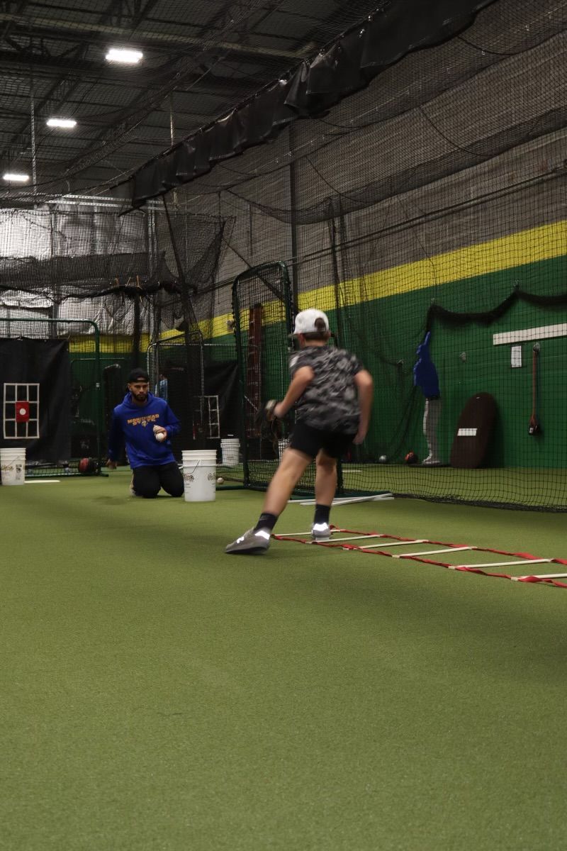 A group of baseball players are huddled together and one has the number 9 on his jersey