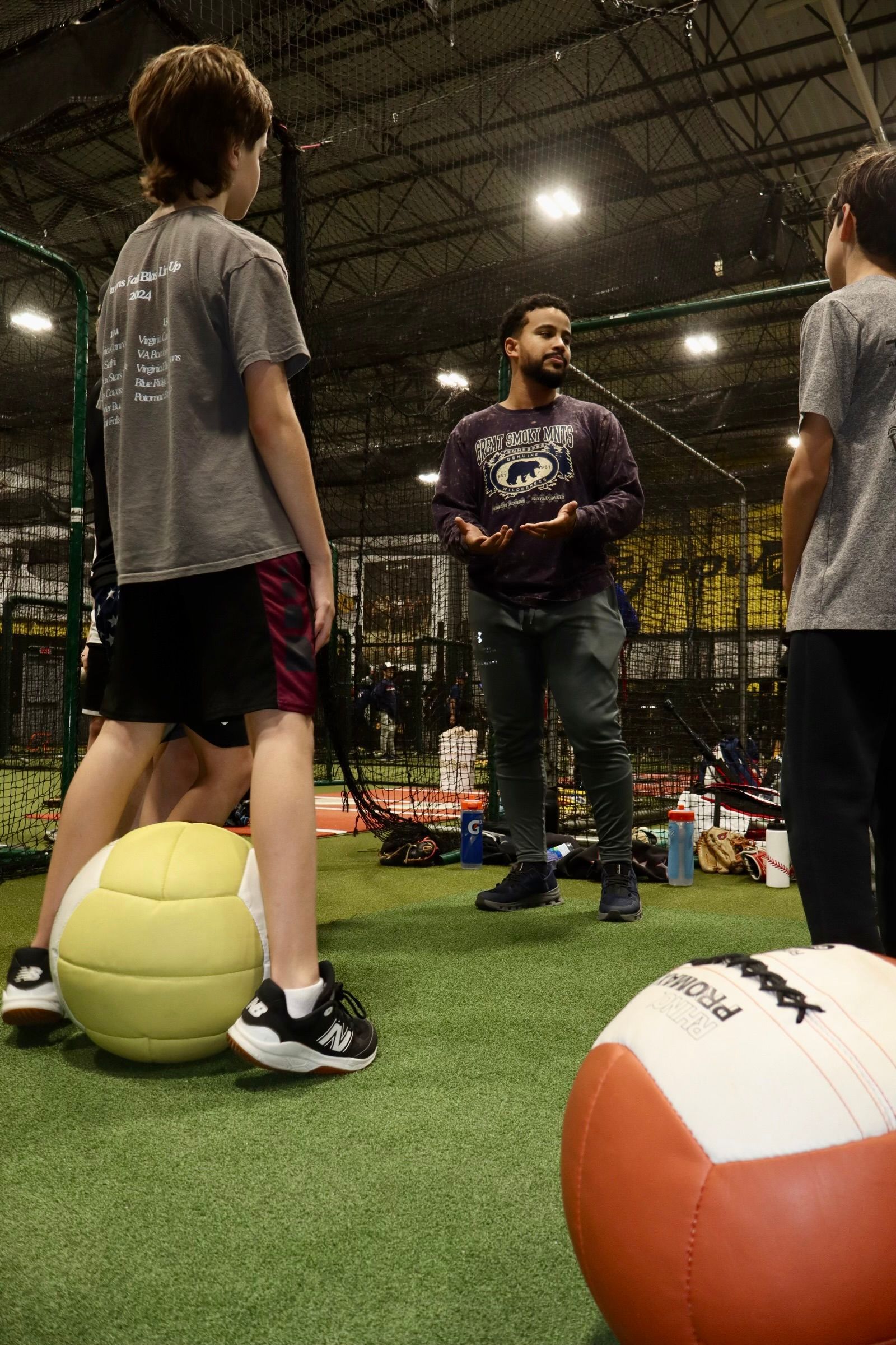 A baseball player is pitching a ball on a field.