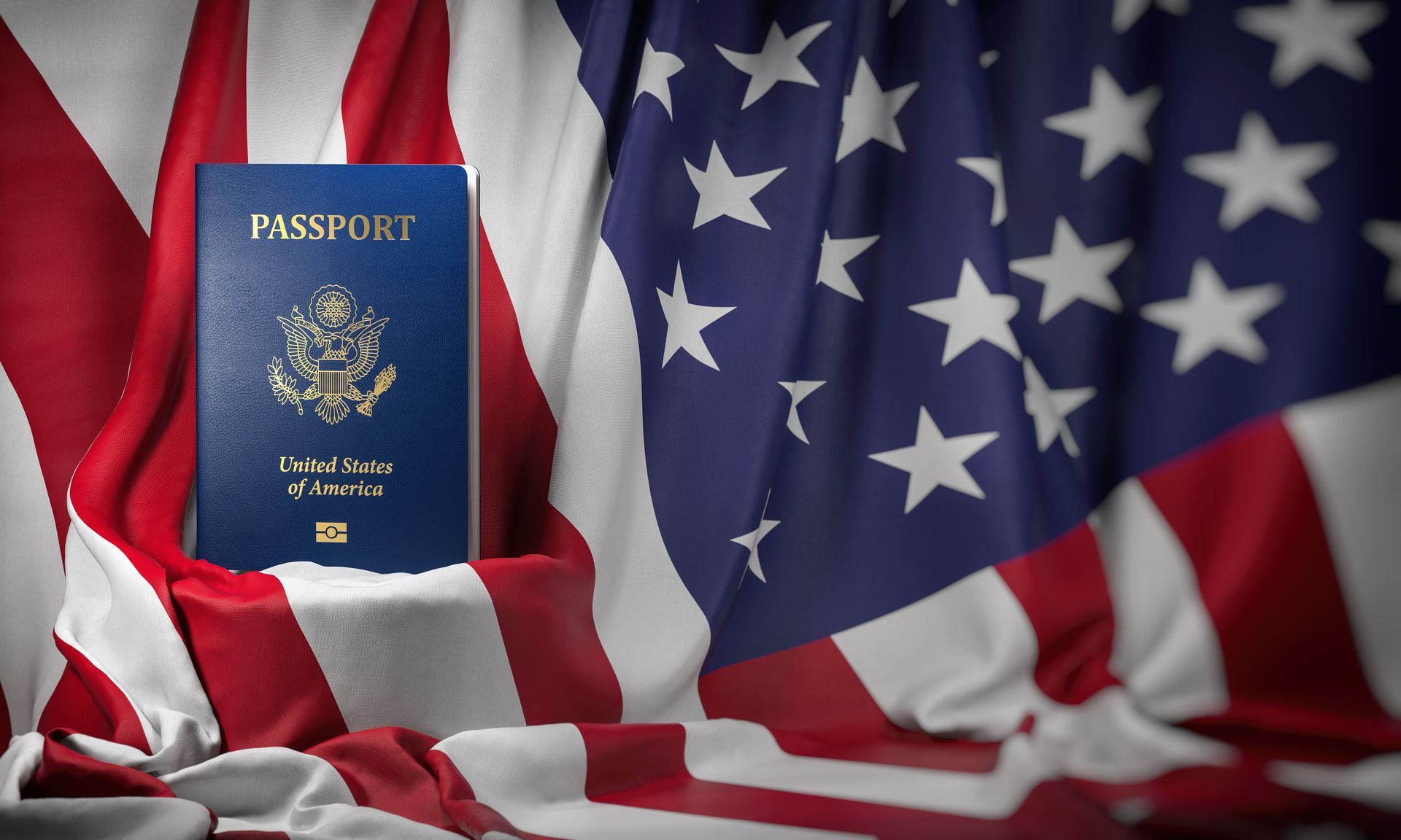 American passport in front of draped American flag, blue and white stars and stripes.
