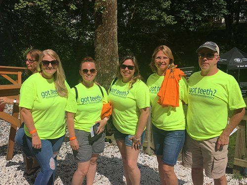 Five people wearing neon green 