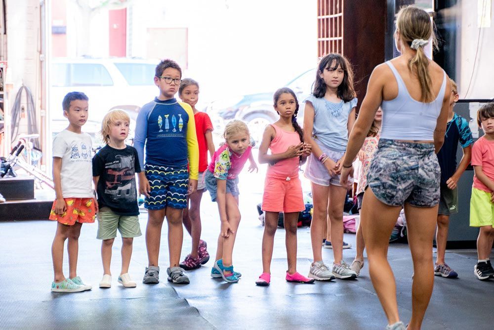 Kids learning from a coach at Gantry Kids