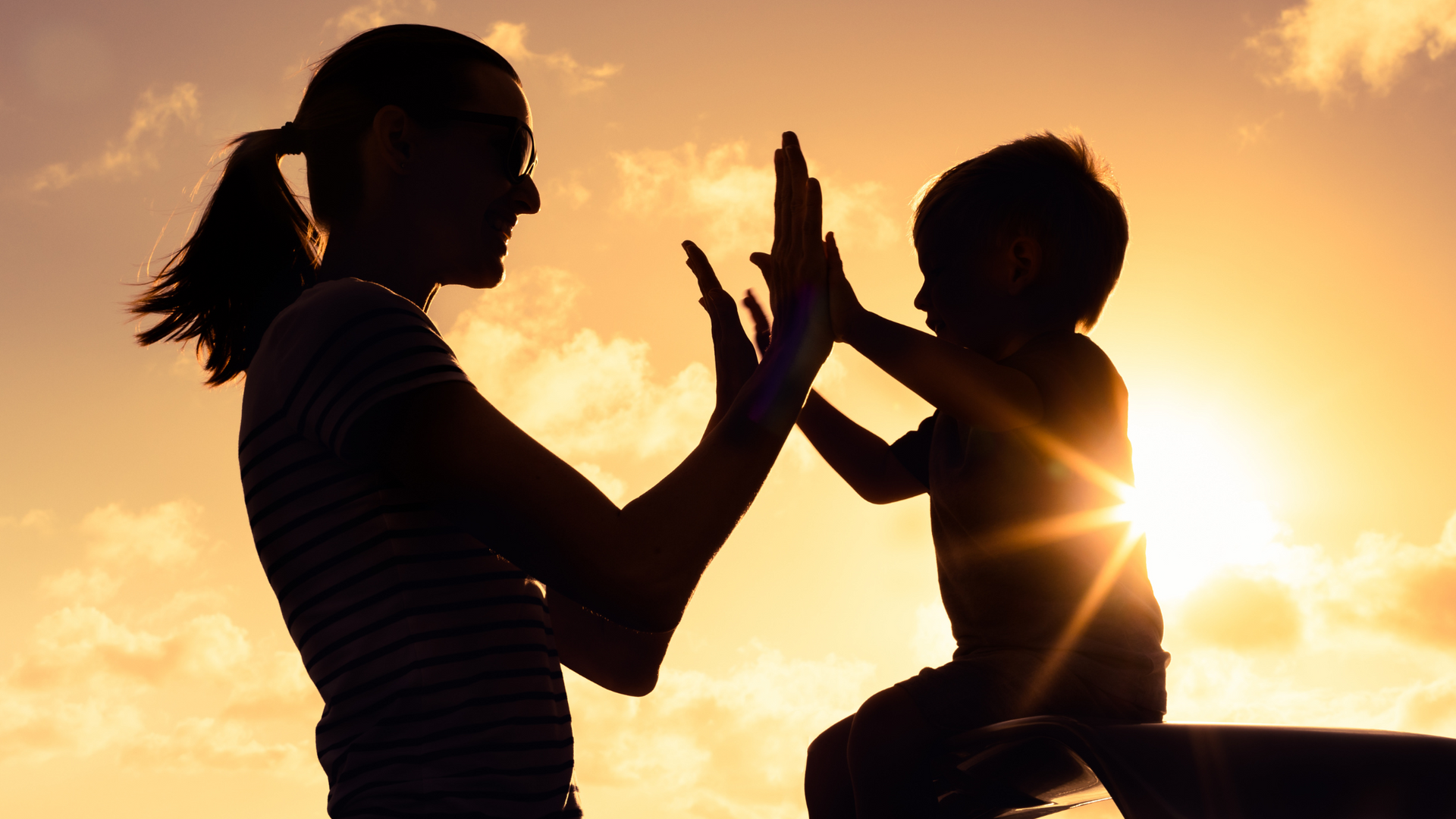 A mother and child giving high fives