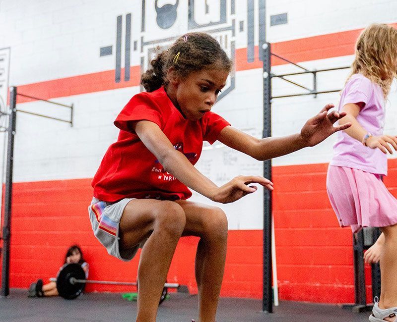 A girl jumping on a block at Gantry Kids in Long Island City