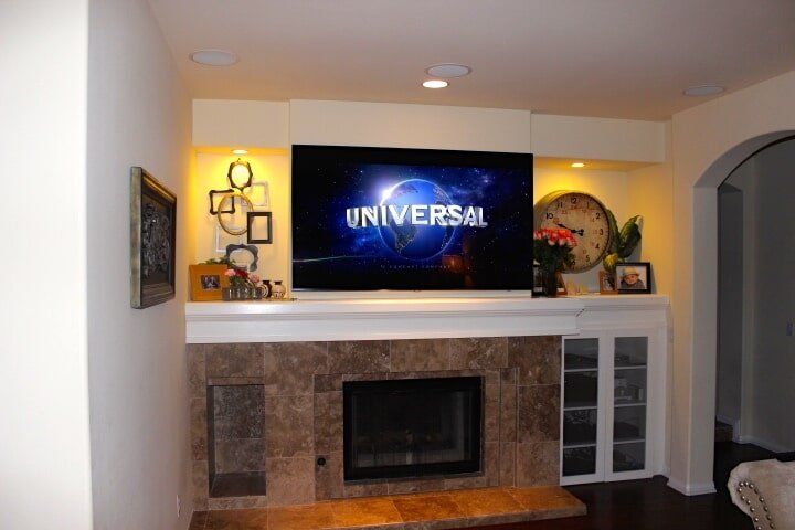 TV Mount over customer fireplace — Hardwood Cabinetry in Carlsbad, CA