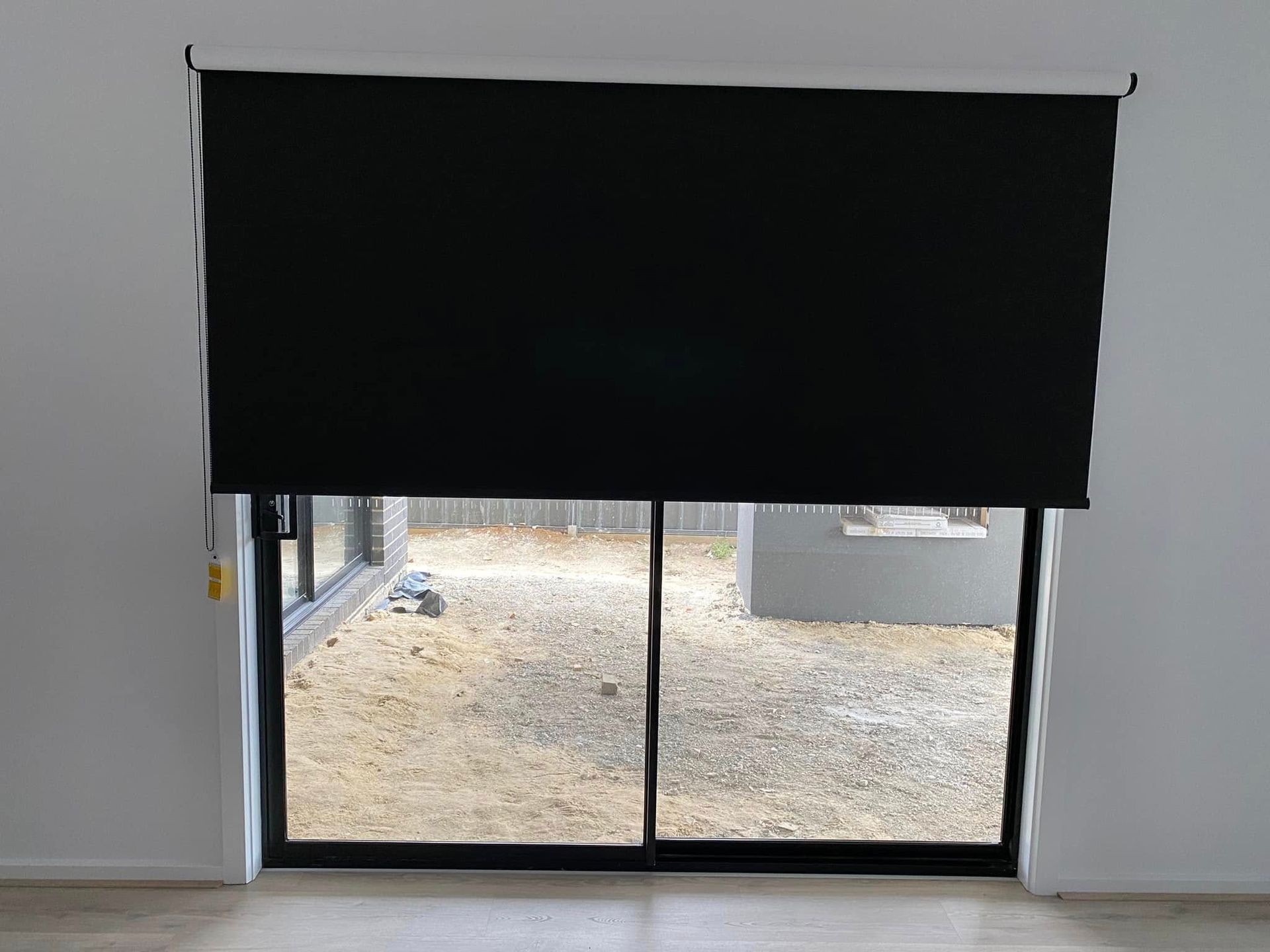 A Sliding Glass Door With A Black Blind On It  — Night & Day Blinds and Awnings in Pakenham, VIC