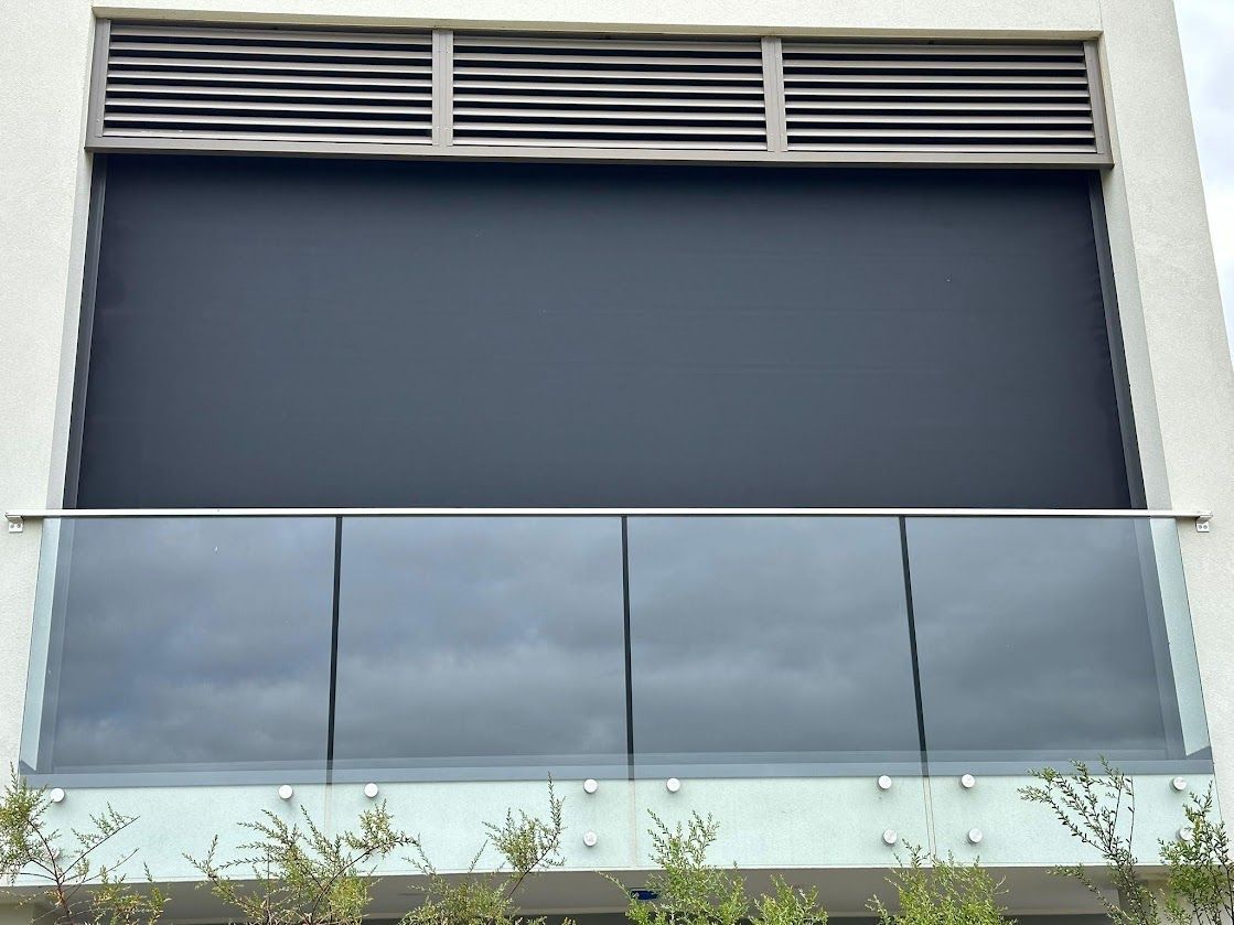 A Deck With Black Roller Blinds  — Night & Day Blinds and Awnings in Pakenham, VIC