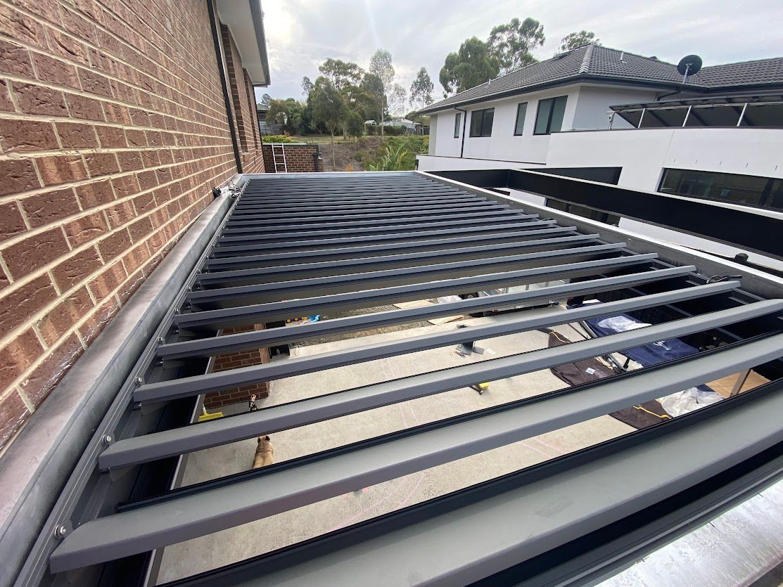 A House With A Covered Patio And A Potted Plant In Front Of It  — Night & Day Blinds and Awnings in Pakenham, VIC
