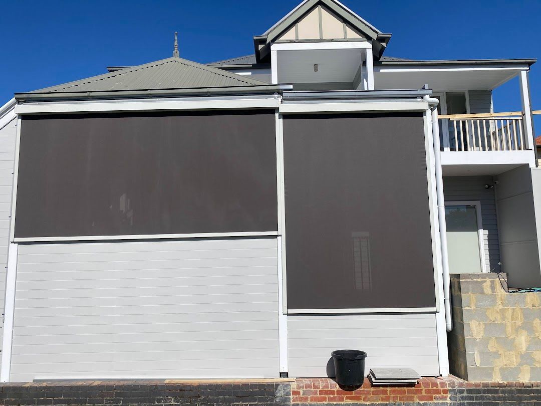 A White House With Black Ziptrak Blinds — Night & Day Blinds and Awnings in Pakenham, VIC