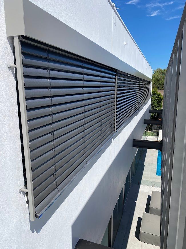 A White House with Grey PVC Blinds on the outside   — Night & Day Blinds and Awnings in Pakenham, VIC