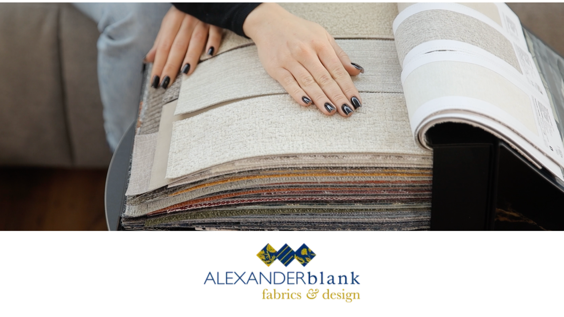 A professional designer looking at a fabric book during consultation at a local drapery shop near Lutherville, MD