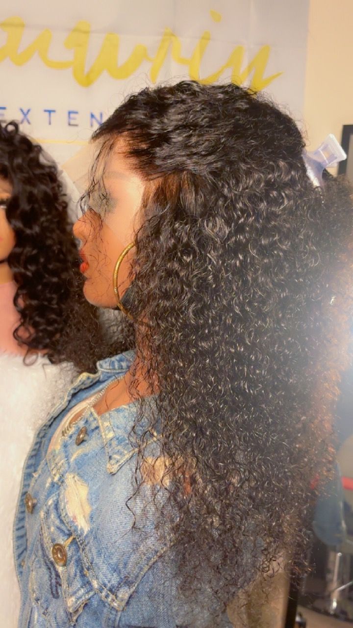 A mannequin wearing a denim jacket and a lace front wig.