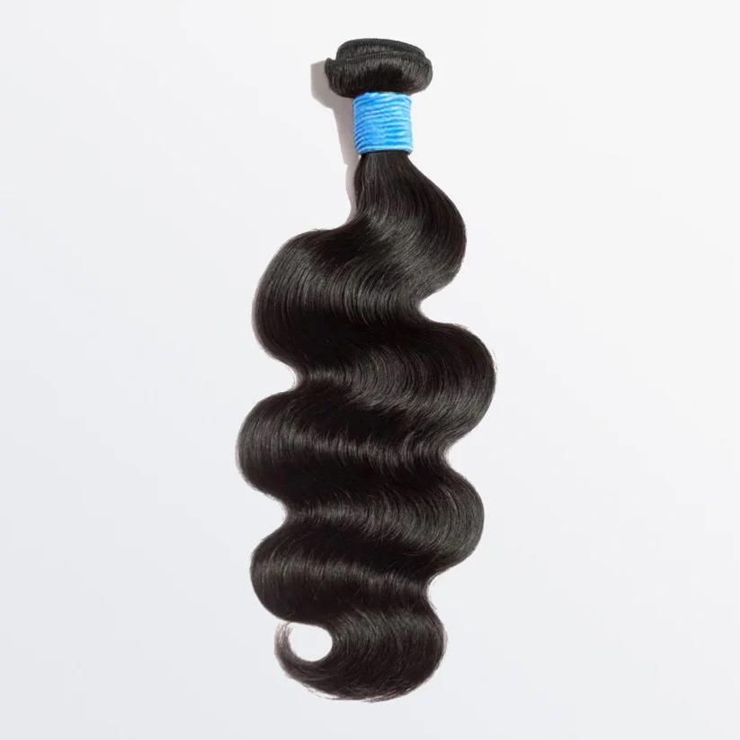 Three bundles of hair are stacked on top of each other on a white surface