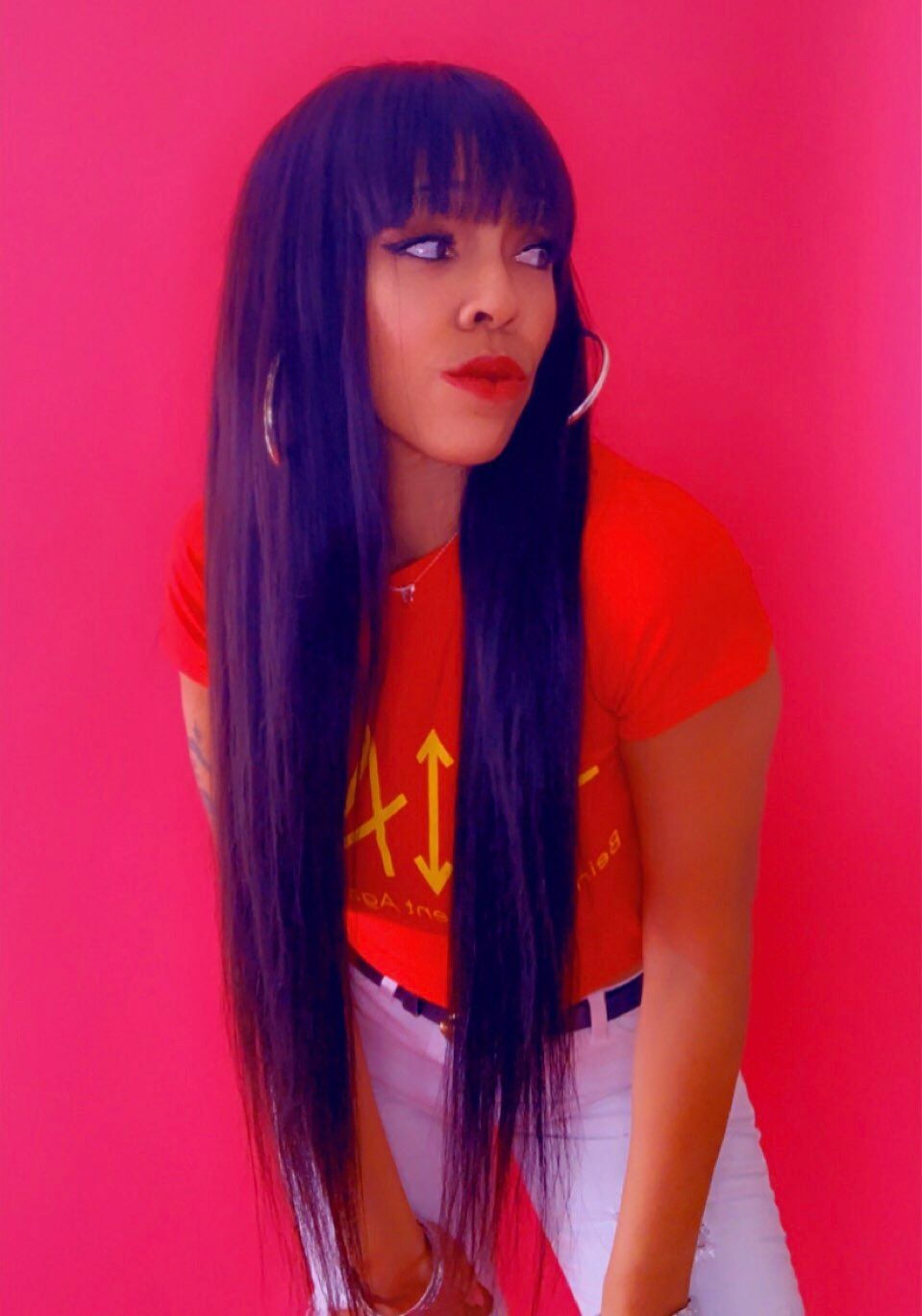 A woman with long hair is wearing a red shirt