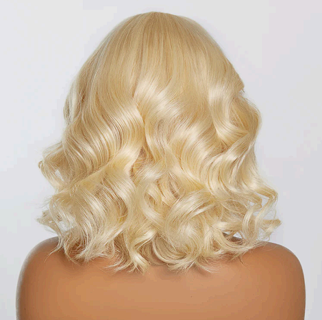 A woman is wearing a blonde lace front wig on a mannequin.