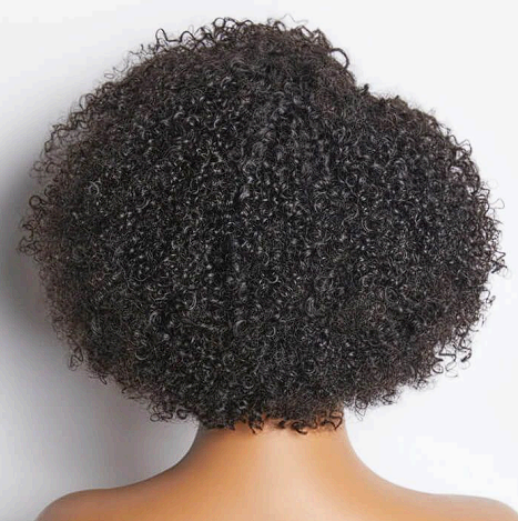 A woman with curly hair is wearing a wig on a mannequin.