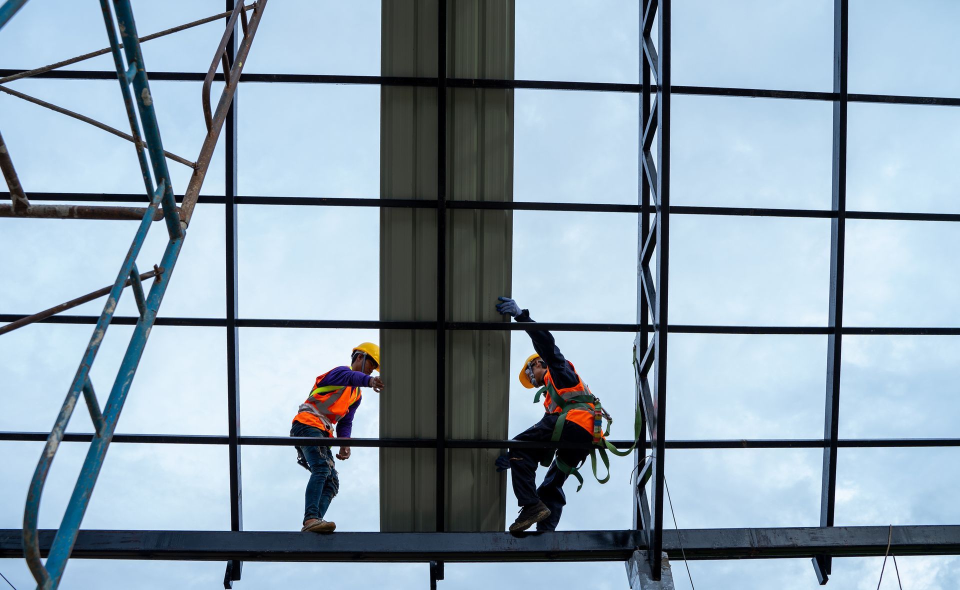 Commercial roofing services contractors in protective gear installing a new roof.