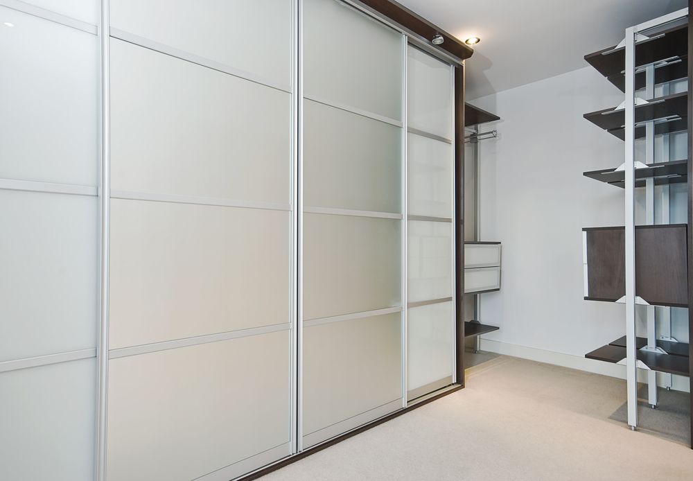 A Walk in Closet With Sliding Glass Doors and Shelves — Ideal Glass In Winnellie, NT