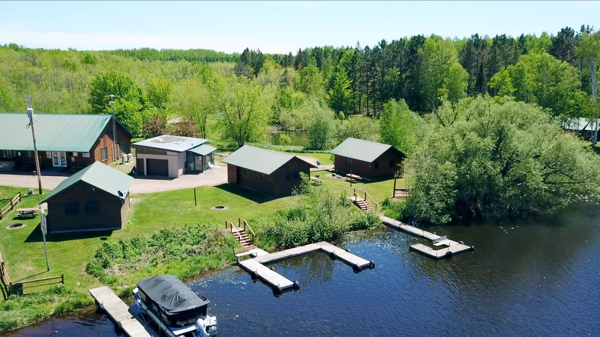 An aerial view of a lake surrounded by houses and trees