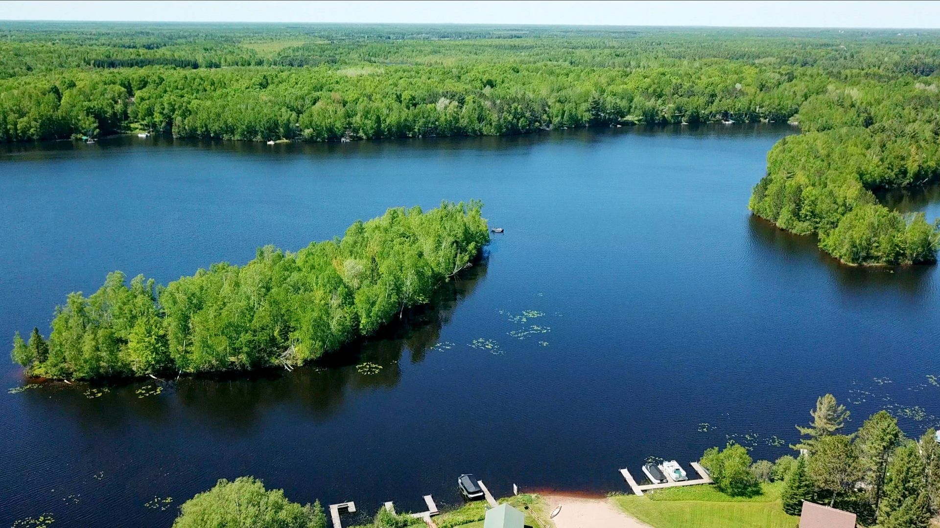 An aerial view of a lake with islands in the middle