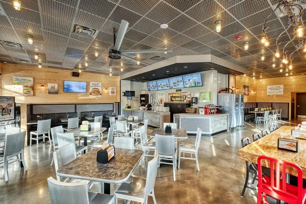 A large dining room with tables and chairs in a restaurant.
