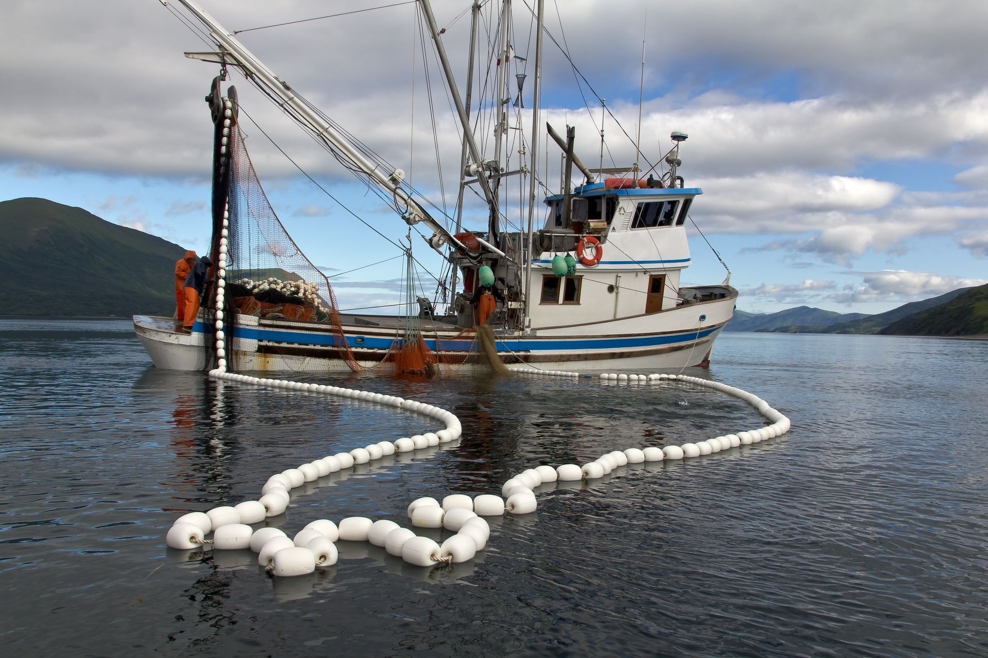 A large blue boat is floating on top of a large body of water