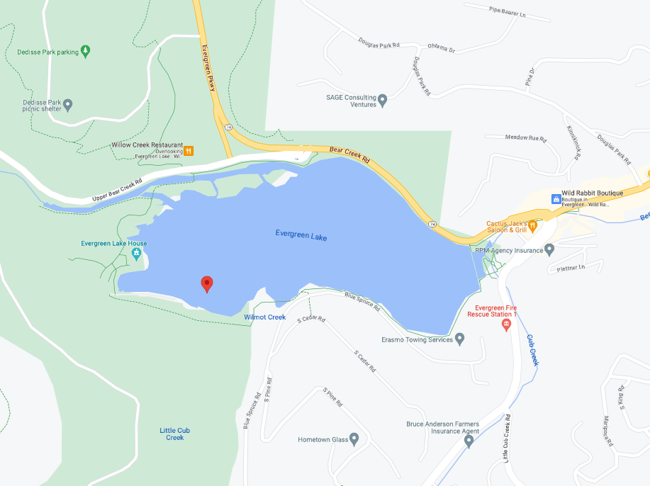 Batman and Wonder Woman in costumes in icy water, raising arms, with onlookers.