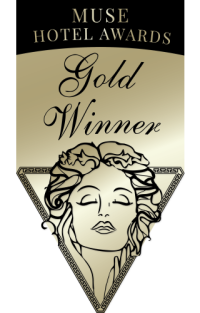 Muse Hotel Awards Gold Winner badge: woman's face, floral hair, gold background.