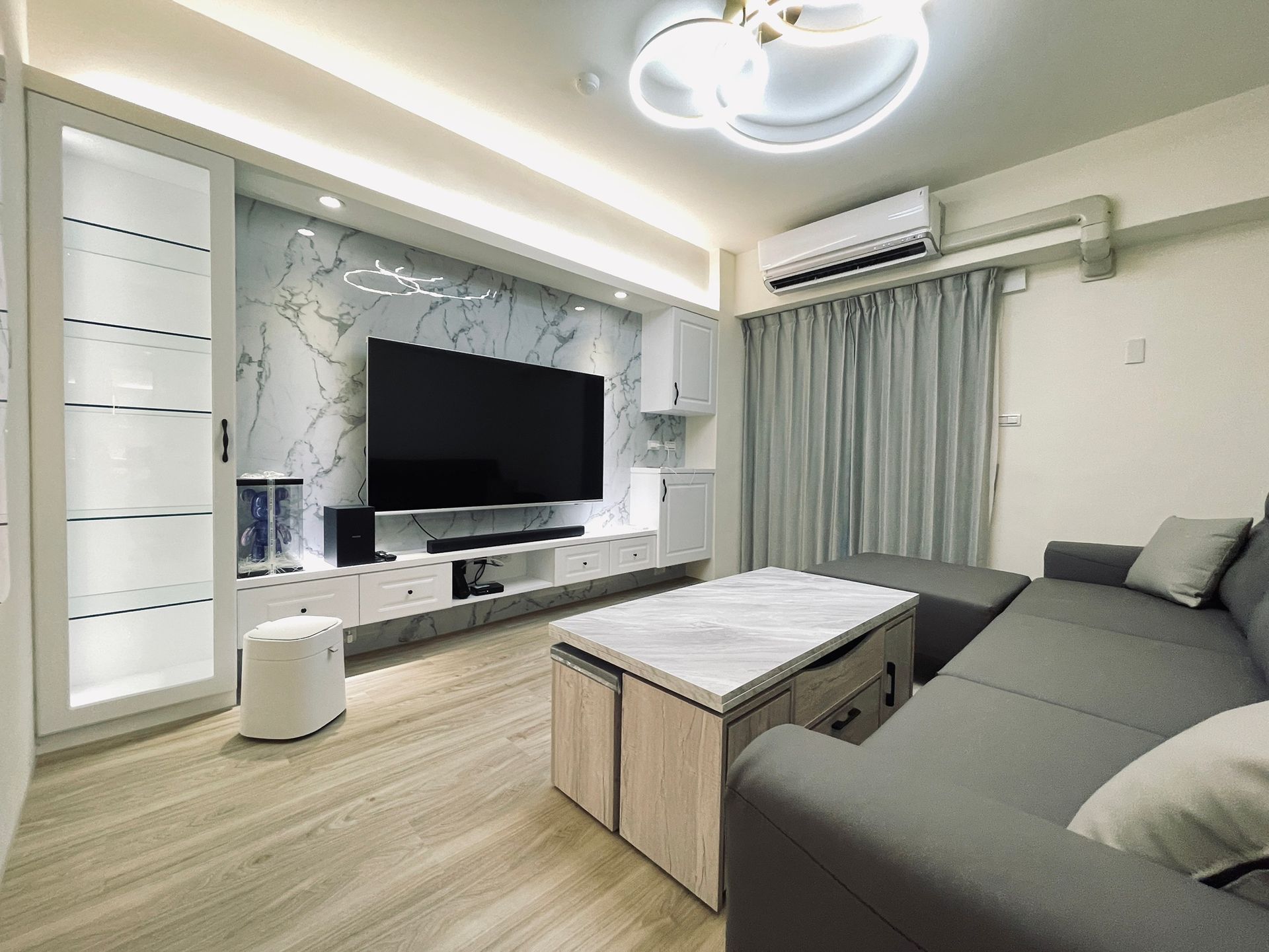 A living room with a couch , television , and coffee table.