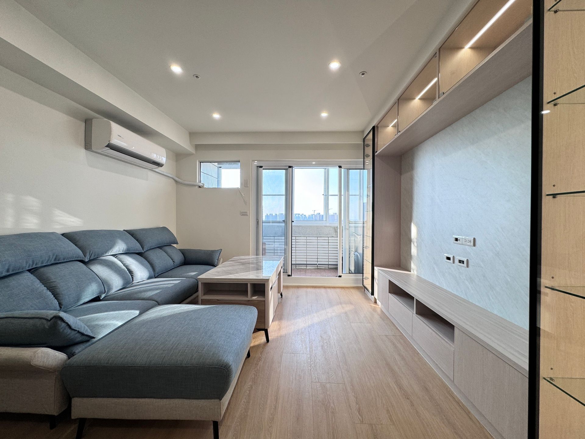 A living room with a couch and a television.