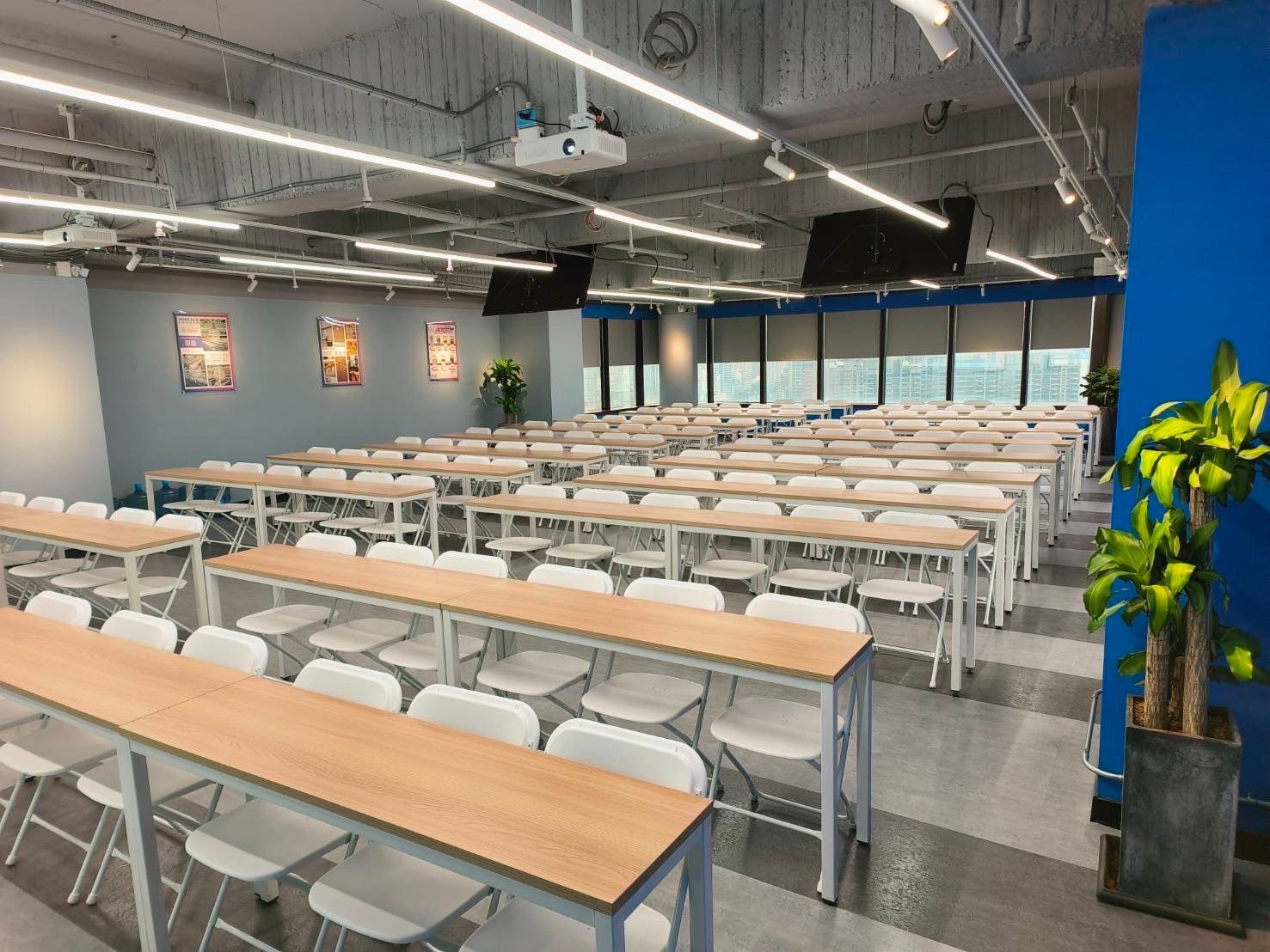 There are a lot of tables and chairs in this room.