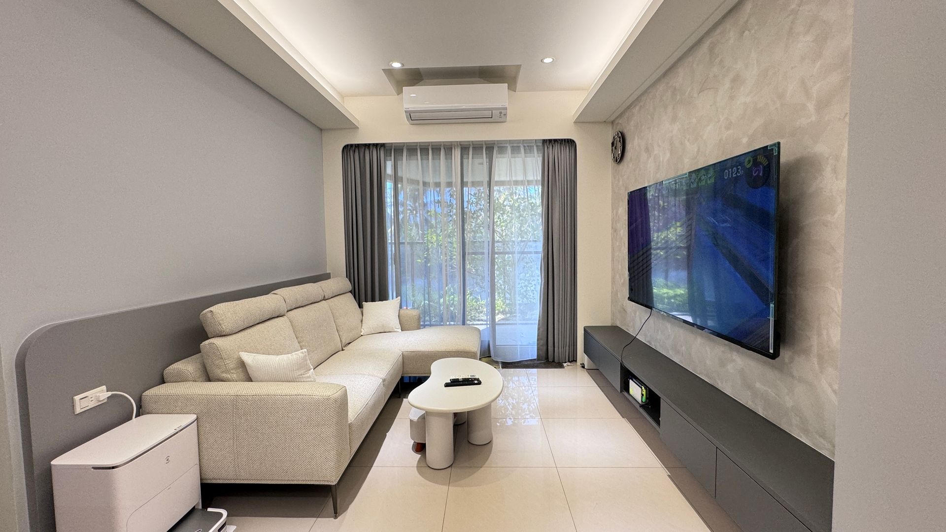 A living room with a couch , table and television.