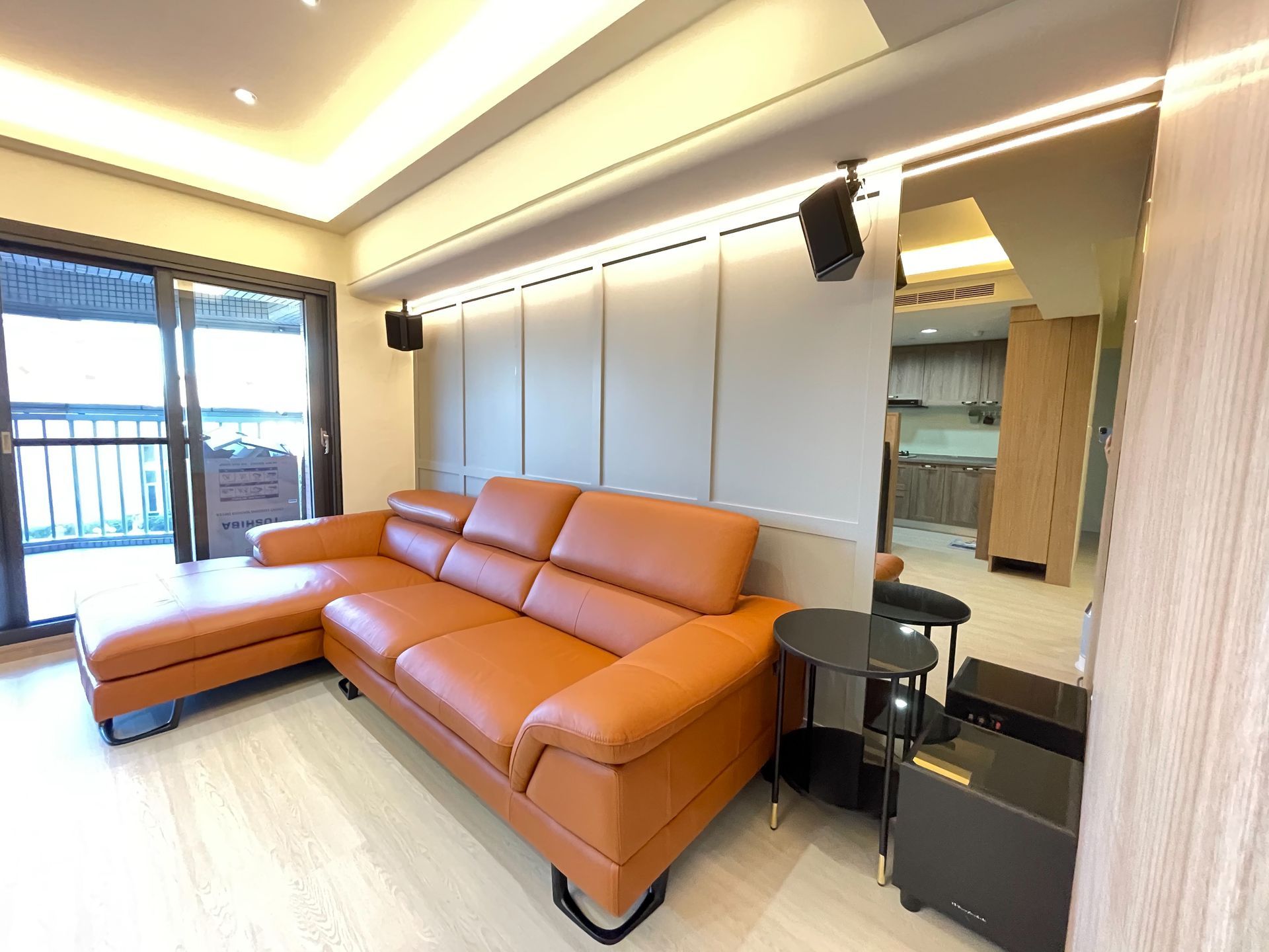 A living room with a brown couch and a table.