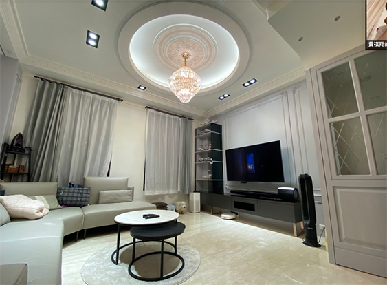 A living room with a couch a table and a television