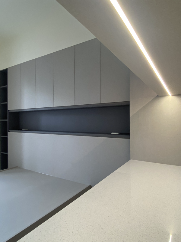 A kitchen with white cabinets and a white counter top