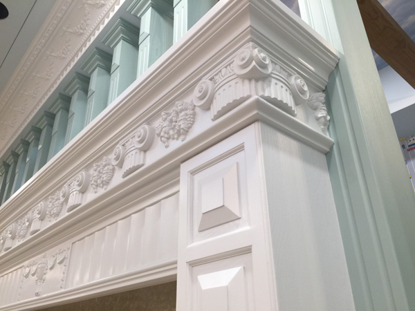 A white door with a fancy molding on it