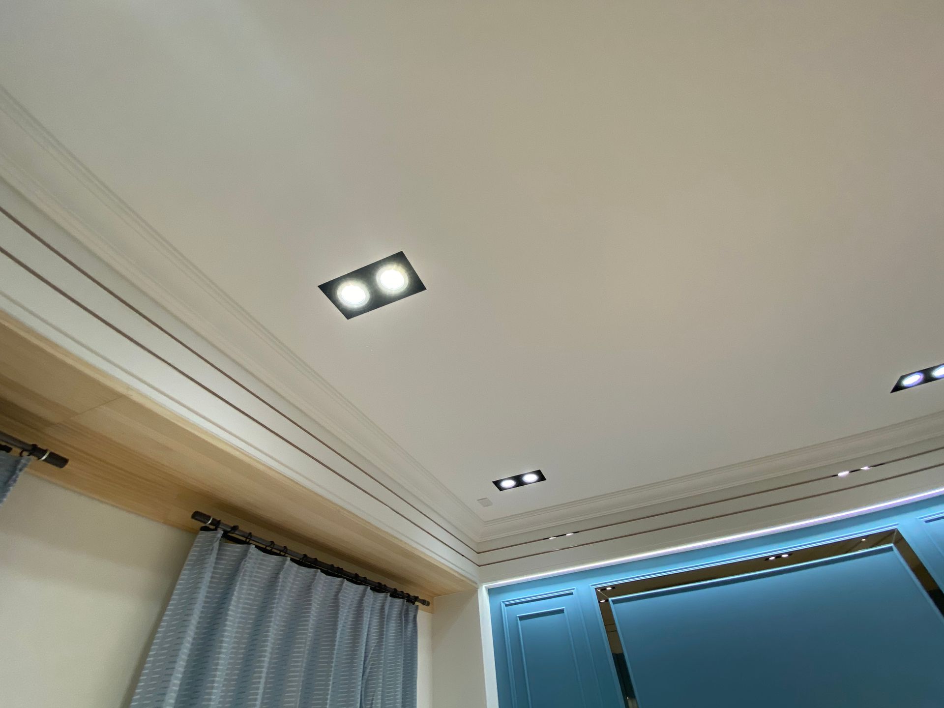 Looking up at the ceiling of a room with curtains