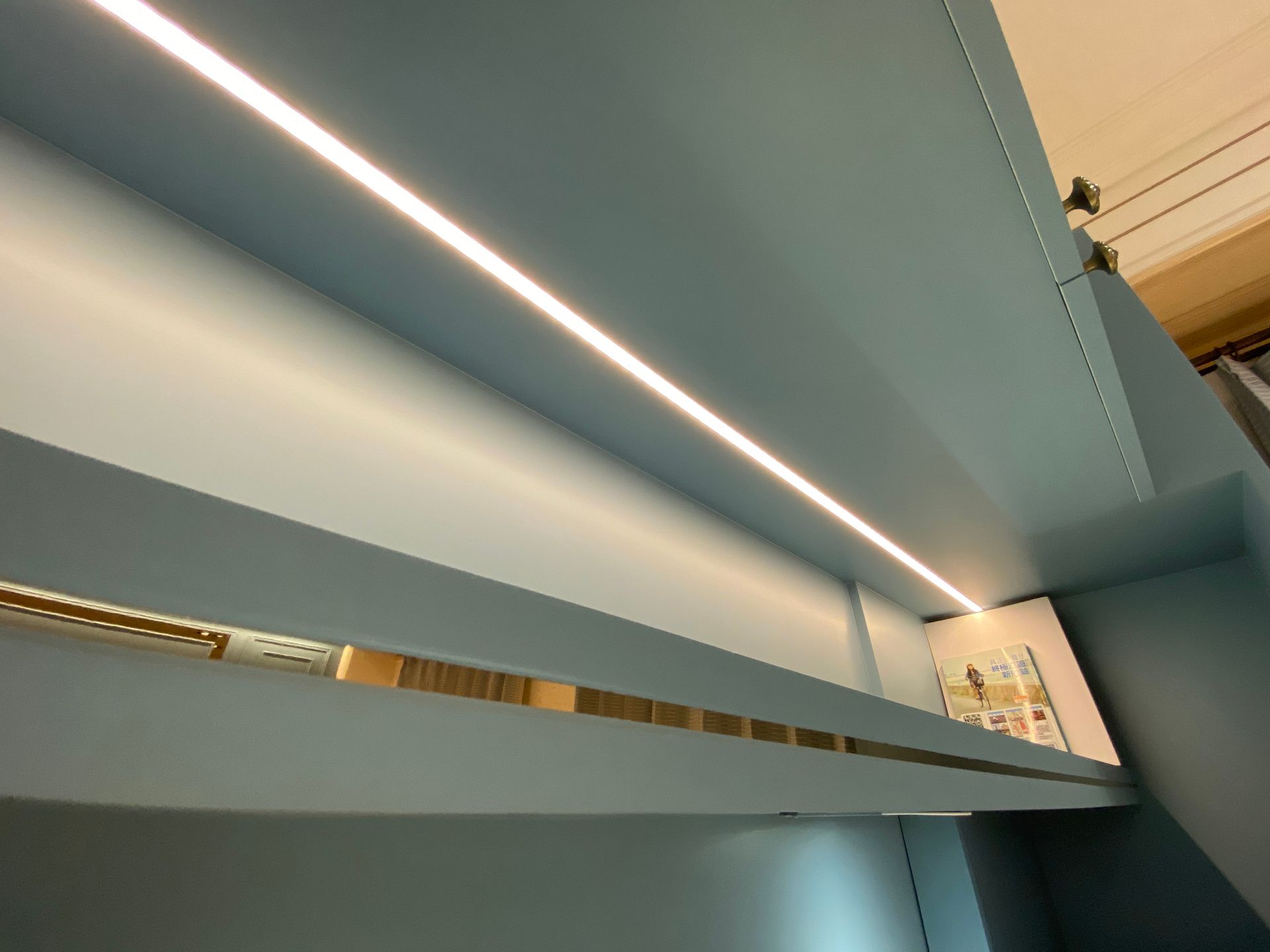 A shelf with a light on it in a room