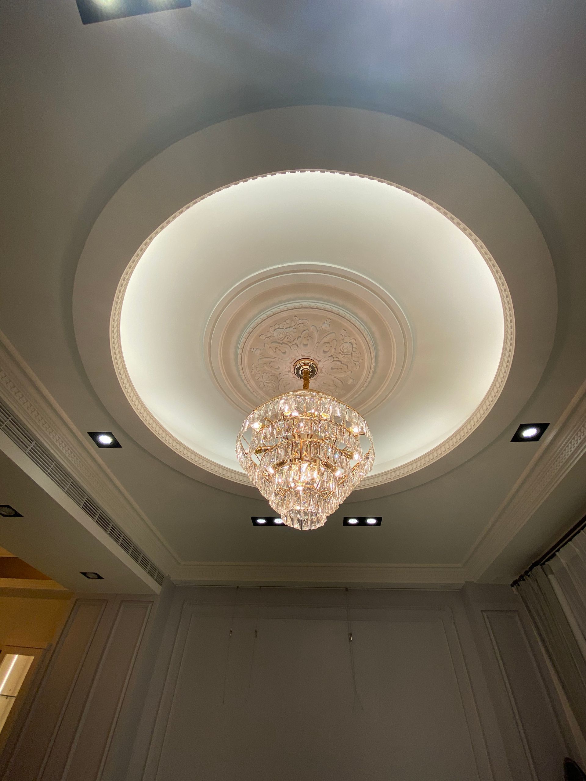 A large chandelier is hanging from the ceiling of a room.