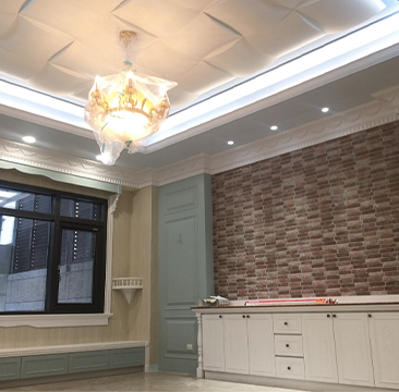 A room with a brick wall and a chandelier hanging from the ceiling