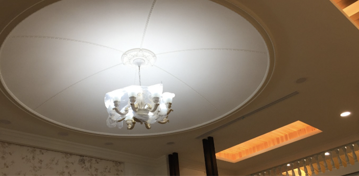 A chandelier is hanging from the ceiling of a room.