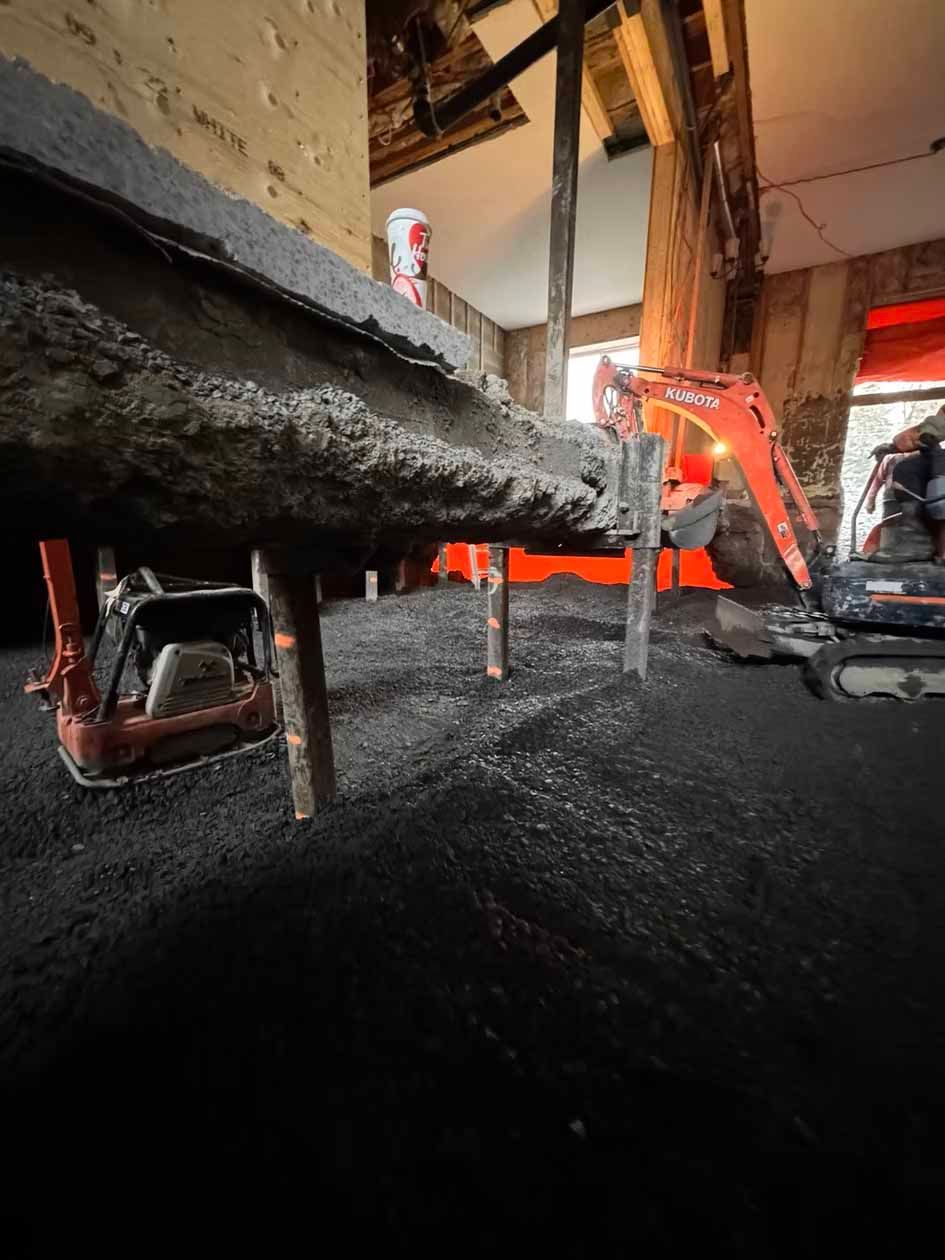 Une excavatrice jouet creuse un trou dans le sol.